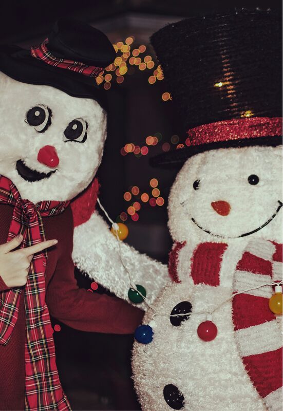 Two people dressed up as snowmen having fun