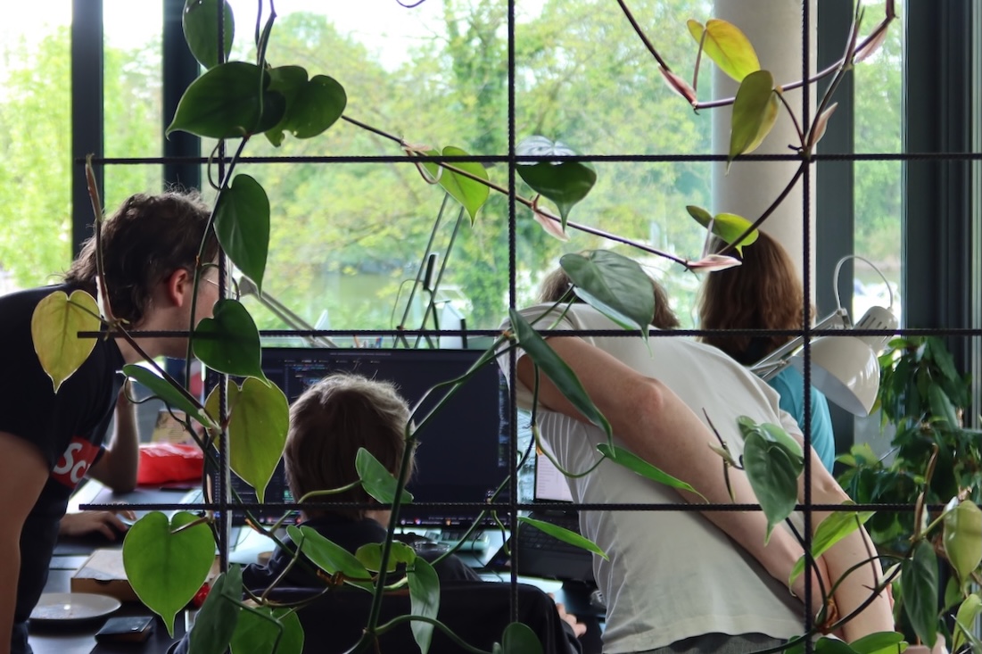 Developers working together at a screen, fine-tuning their code