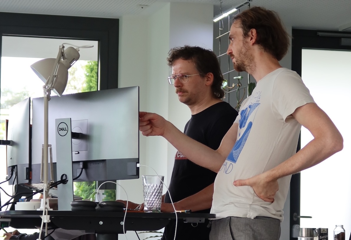 Developers working together at a screen, fine-tuning their code